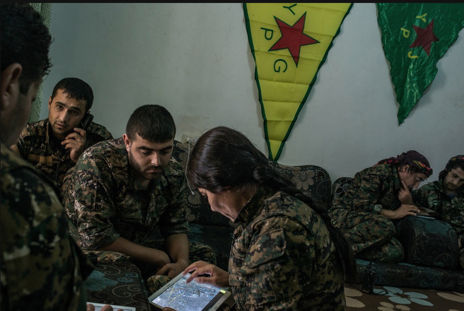 Kurds checking targets on tablets' maps to determine where Ameican combat missions may strike