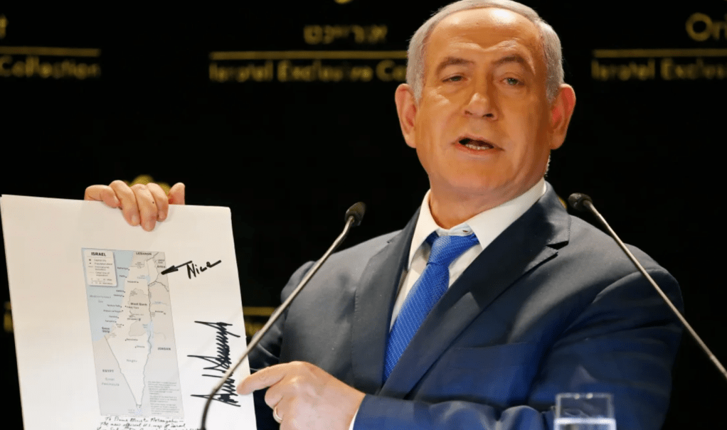 Prime Minister Benjamin Netanyahu displays a map of Israel indicating the Golan Heights are inside the state's borders, signed by US president Donald Trump on May 30, 2019. (Thomas COEX / AFP)